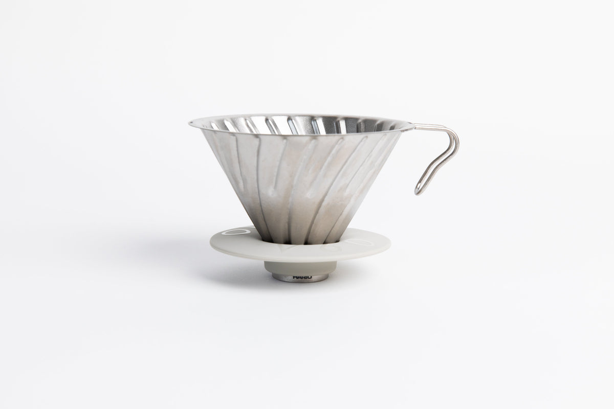 Silver metal coffee cone dripper with handle on a white background