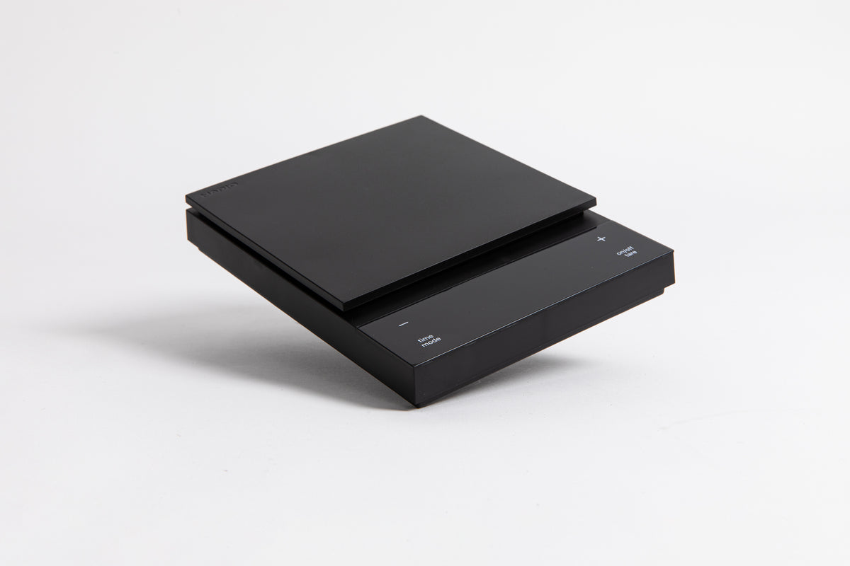 Sleek black digital square scale with a flat surface and clear LED display. set on a white background.