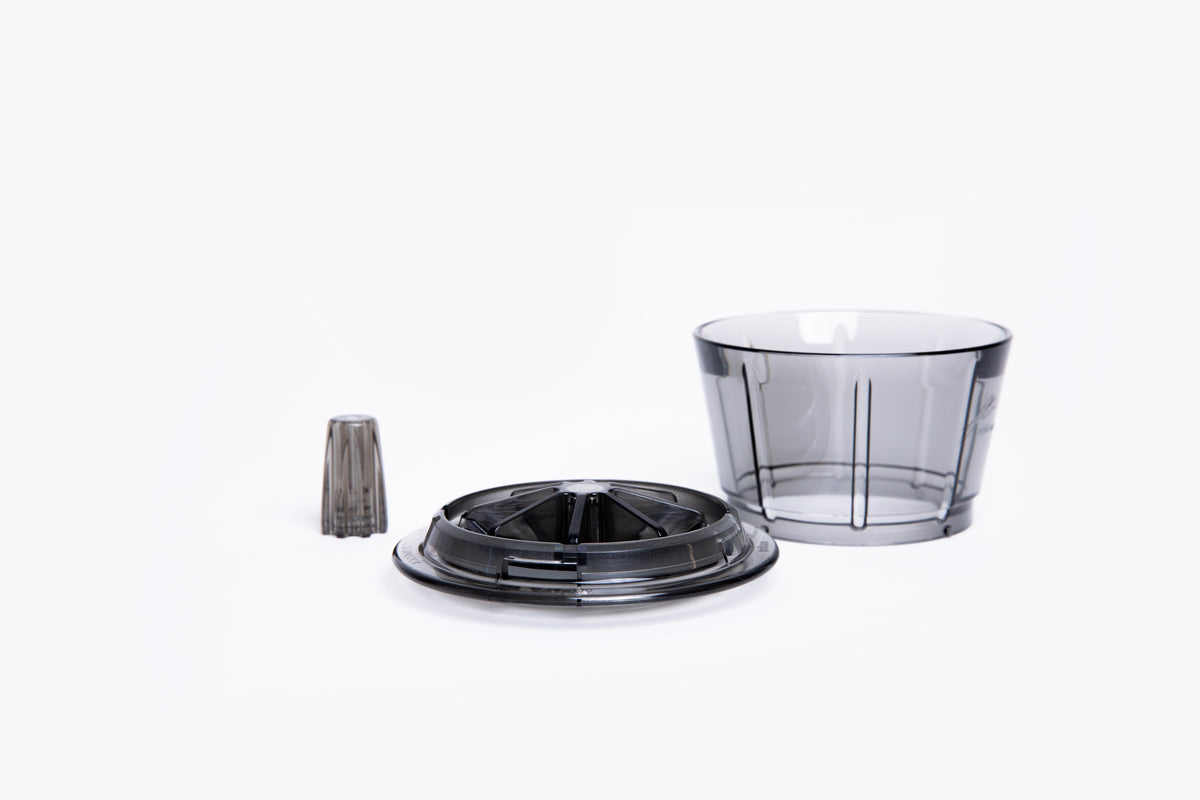 Transparent gray plastic coffee dripper with a wide base and integrated ridges, removable base and center insert on white background.