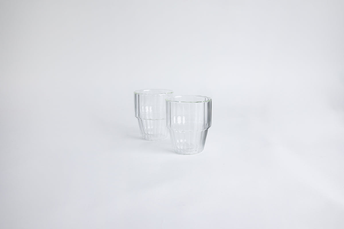 2 ribbed clear glass cup on a white background