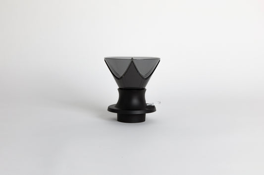 Translucent black plastic cone shaped dripper with Bézier ridges in a black silicone base with clear plastic push switch