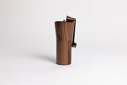 Wooden cylindrical coffee grinder on a white background