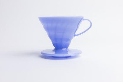 Purple plastic cone coffee dripper with handle on a white background