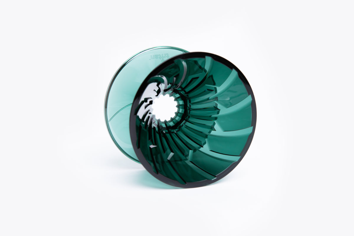 transparent green plastic cone dripper with interior ribbing on a white background