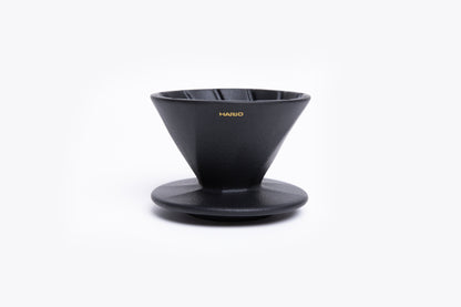Black coffee dripper with 'Hario' branding on a white background
