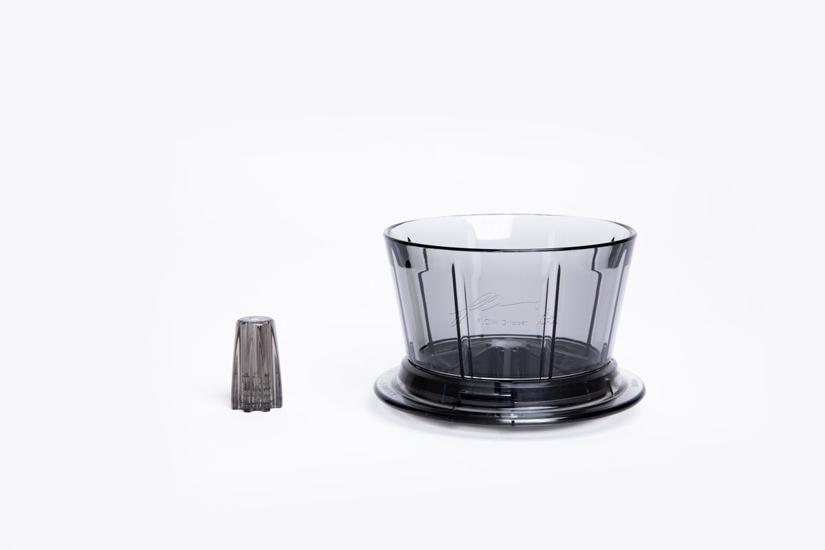 Transparent gray plastic coffee dripper with a flat base with removal center insert on white background