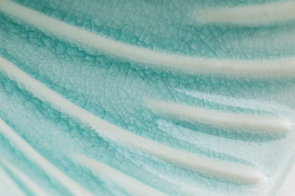 Close-up of the interior of a teal-colored pour-over cone, showcasing the crackle teal glaze finish. The raised ribs inside the cone are white