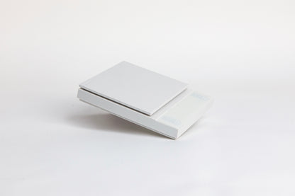 white digital square scale with a flat surface and clear LED display. set on a white background.