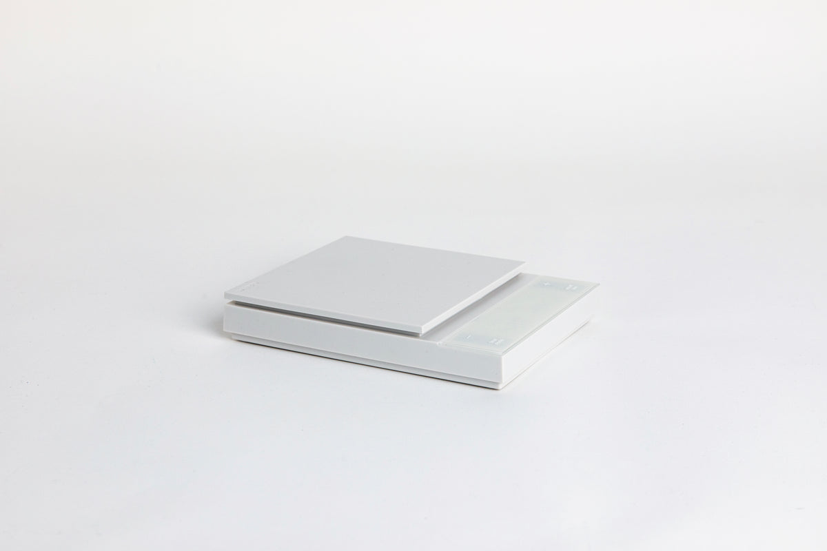 white digital square scale with a flat surface and clear LED display. set on a white background.