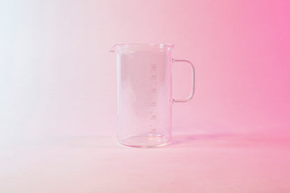 Clear glass coffee server with milliliter markings from 100 to 600 and full glass handle.
