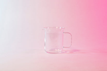 Clear glass coffee server with millileter markings from 100 to 300 and full glass handle.
